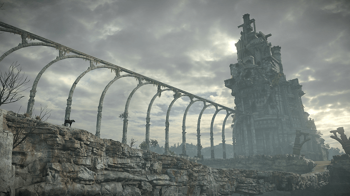 shadow of the colossus screenshot with an abandoned stone temple and the main character on horse crossing bridge