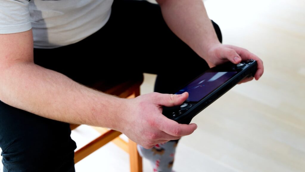 A Person Playing on Steam Deck While Seated